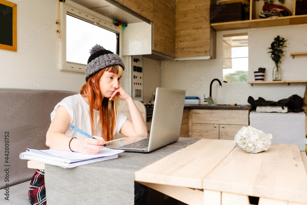 Traveling woman working remotely in van Traveling woman working remotely in van