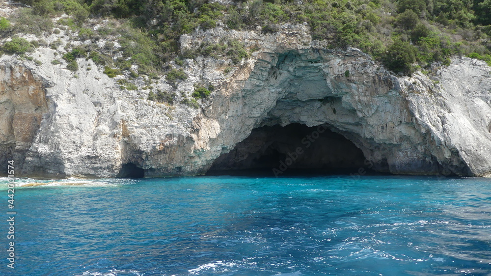blue sea and rocks in Greece with cave