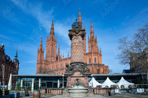market church in Wiesbaden with historic market pillar with fountain under blue sky