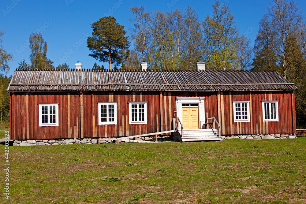 an ancient wooden farmhouse with a low roof
