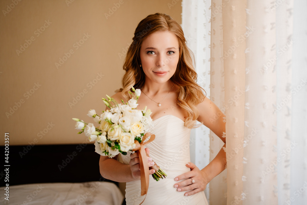 portrait of a beautiful bride with a bouquet by the window. Wedding traditions. portrait of a beautiful bride with a bouquet by the window. Wedding traditions.