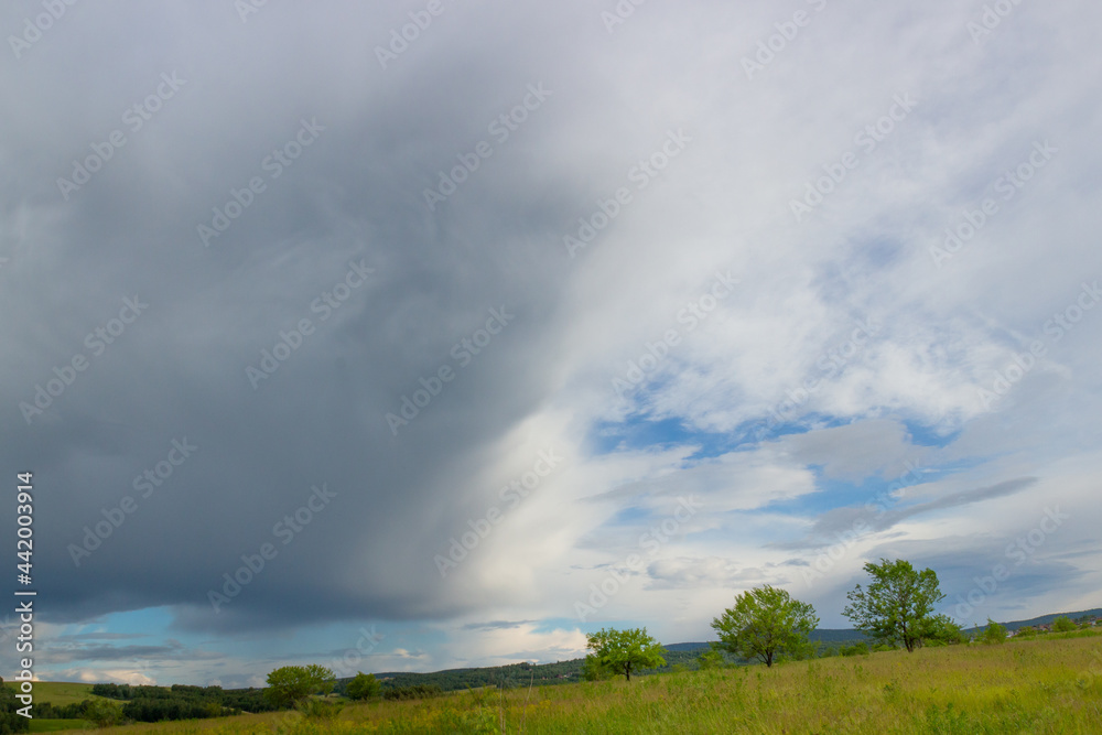 Summer landscape on field before the storm. Awe clouds before the rain