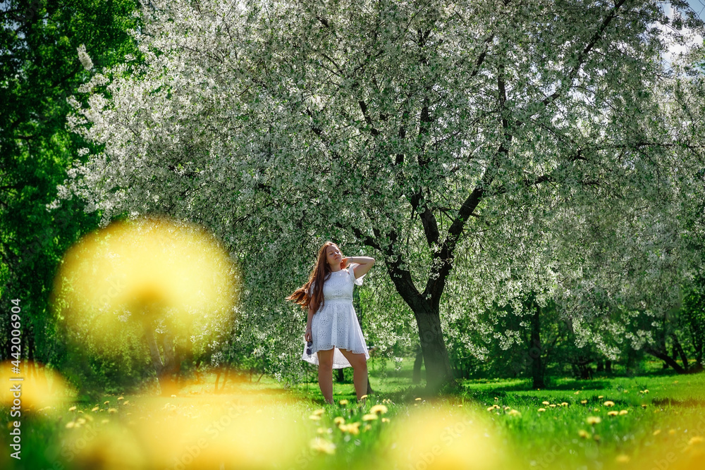 Beautiful girl outdoors. Summer Park. Long hair. A white dress. Beautiful girl outdoors. Summer Park. Long hair. A white dress.
