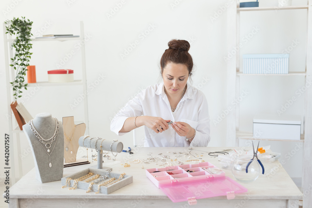 Professional accessories designer making handmade jewelry in studio workshop. Fashion, creativity and handmade concept. Professional accessories designer making handmade jewelry in studio workshop. Fashion, creativity and handmade concept.