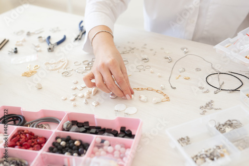 Fototapeta Professional jewelry designer making handmade jewelry in studio workshop close-up