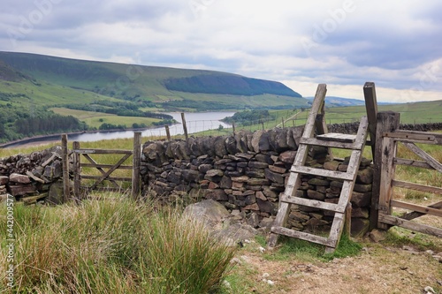 dry stone wall with gate and stile steps ladder countryside view 
