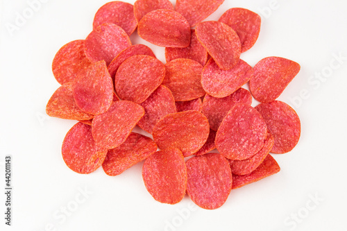 Red chips with hot pepper taste on a white background. Beer snack.
