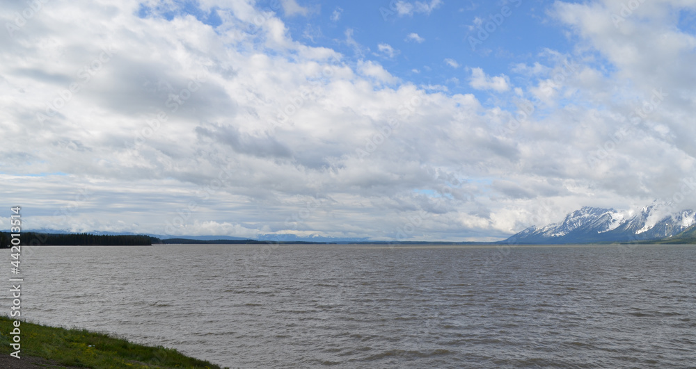 Late Spring in Grand Teton National Park: Looking South Across the Water at a Cloud-filled Sky and the Teton Range from Jackson Lake Overlook