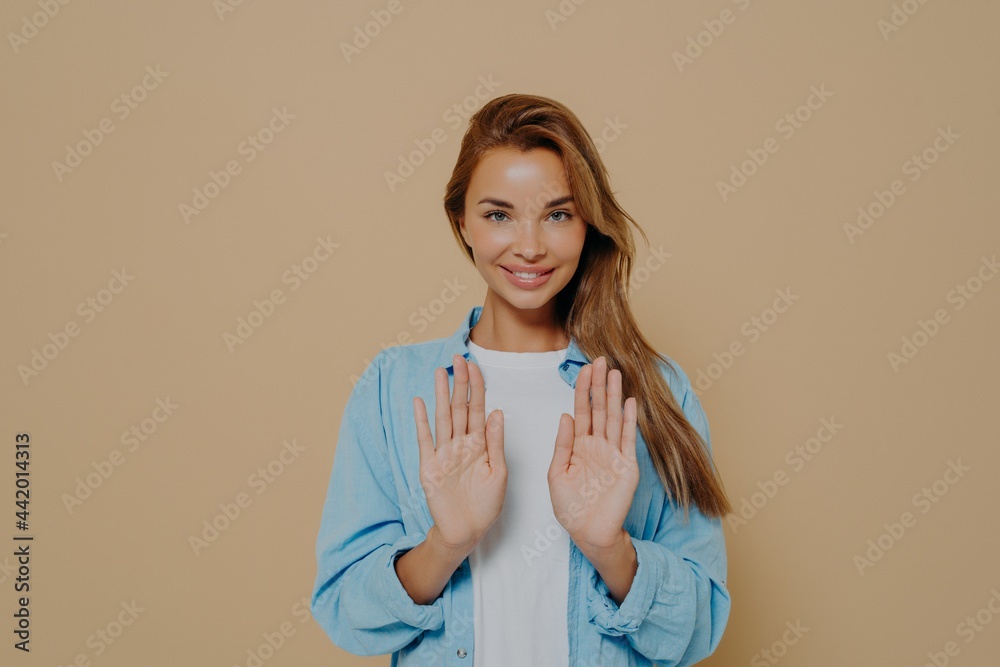 Smiling young female model with stright long hair wearing oversized blue shirt Smiling young female model with stright long hair wearing oversized blue shirt