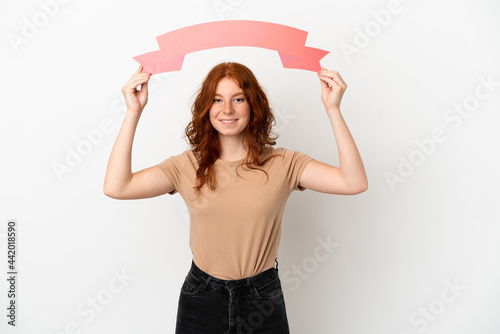 Teenager redhead girl isolated on white background holding an empty placard