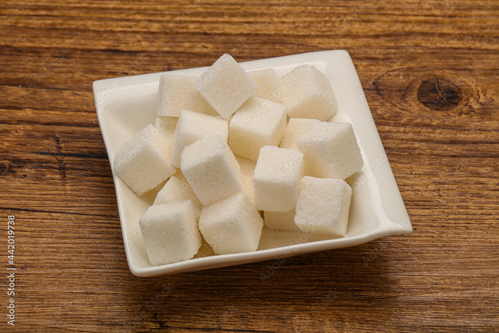 Refined white sugar cubs in the bowl Refined white sugar cubs in the bowl