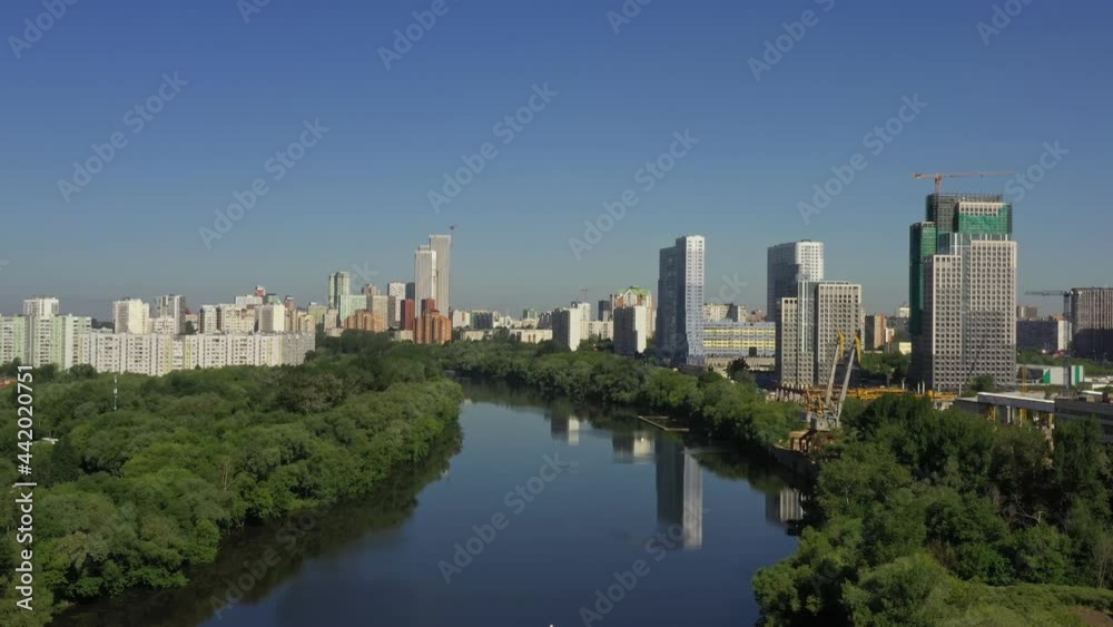 View of a modern developing modern city. modern houses on the embankment of the Moskva river. in summer. aerial view View of a modern developing modern city. modern houses on the embankment of the Moskva river. in summer. aerial view