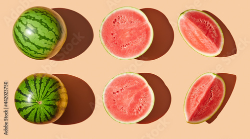 Cut watermelons on orange pastel background