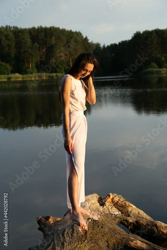 Outside portrait of brunette woman in white dress