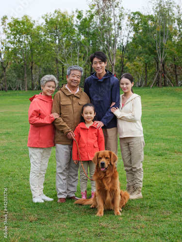 Happy family of five and pet dog in the park
