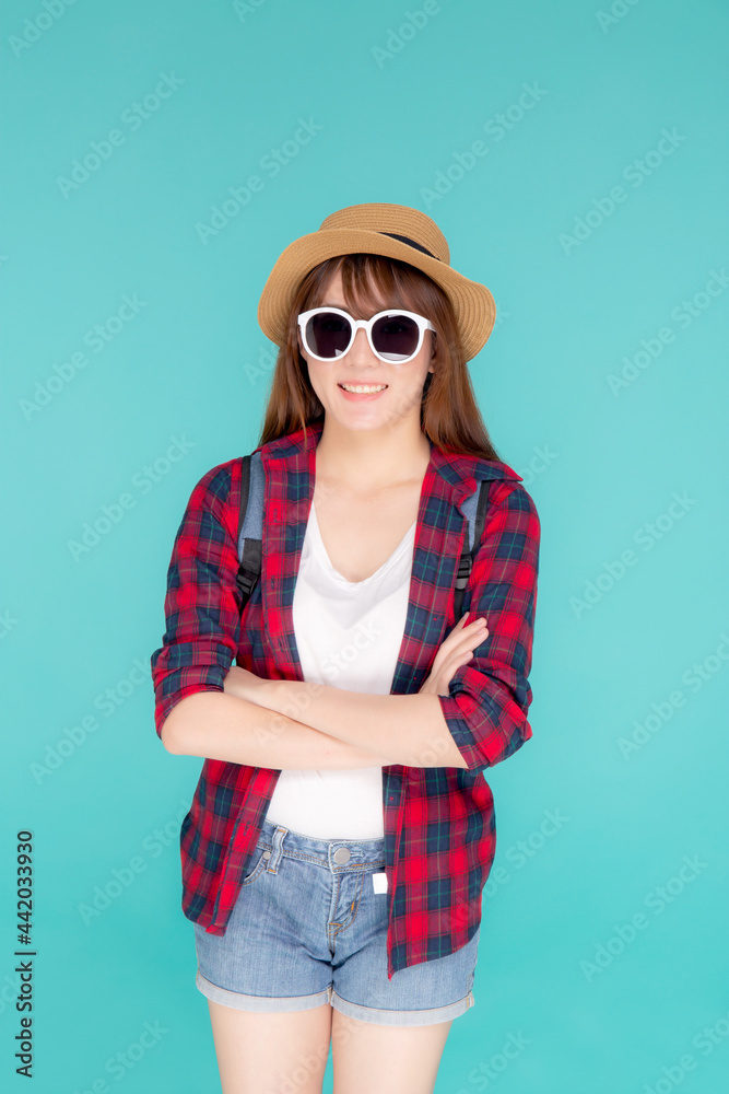 Beautiful portrait young asian woman wear sunglasses and hat smile expression confident enjoy summer holiday isolated blue background, model girl fashion having backpack, travel concept. Beautiful portrait young asian woman wear sunglasses and hat smile expression confident enjoy summer holiday isolated blue background, model girl fashion having backpack, travel concept.