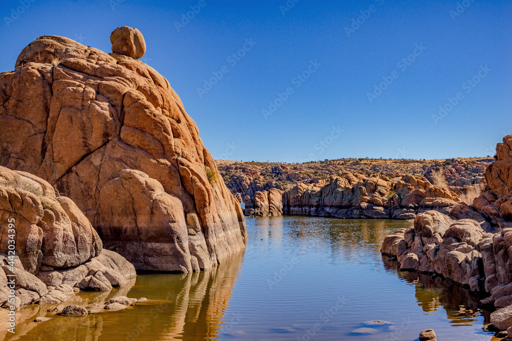 red granite boulders in mountain lake