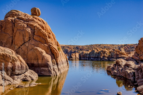 red granite boulders in mountain lake photo