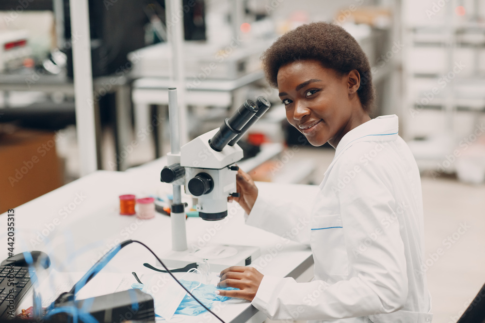 Color woman in tech. Scientist african american woman working in laboratory with electronic tech instruments and microscope. Color woman in tech. Scientist african american woman working in laboratory with electronic tech instruments and microscope.