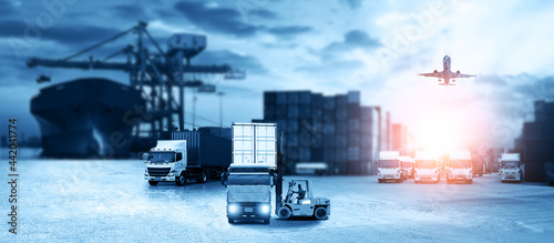 Container truck in ship port for business Logistics and transportation of Container Cargo ship and Cargo plane with working crane bridge in shipyard, logistic import export and transport concept © Travel mania