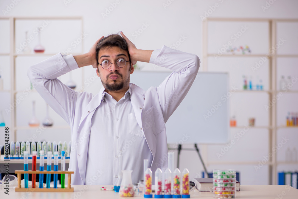 Young male chemist in drugs synthesis concept Young male chemist in drugs synthesis concept
