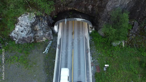 Looking down at traffic passing through tunnel entrance E16 highway between Bergen and Voss Norway - Dalekvam Beitlatunnel static aerial birdseye view photo