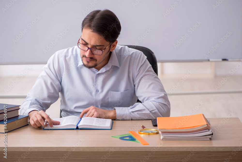 Young male teacher in front of whiteboard Young male teacher in front of whiteboard