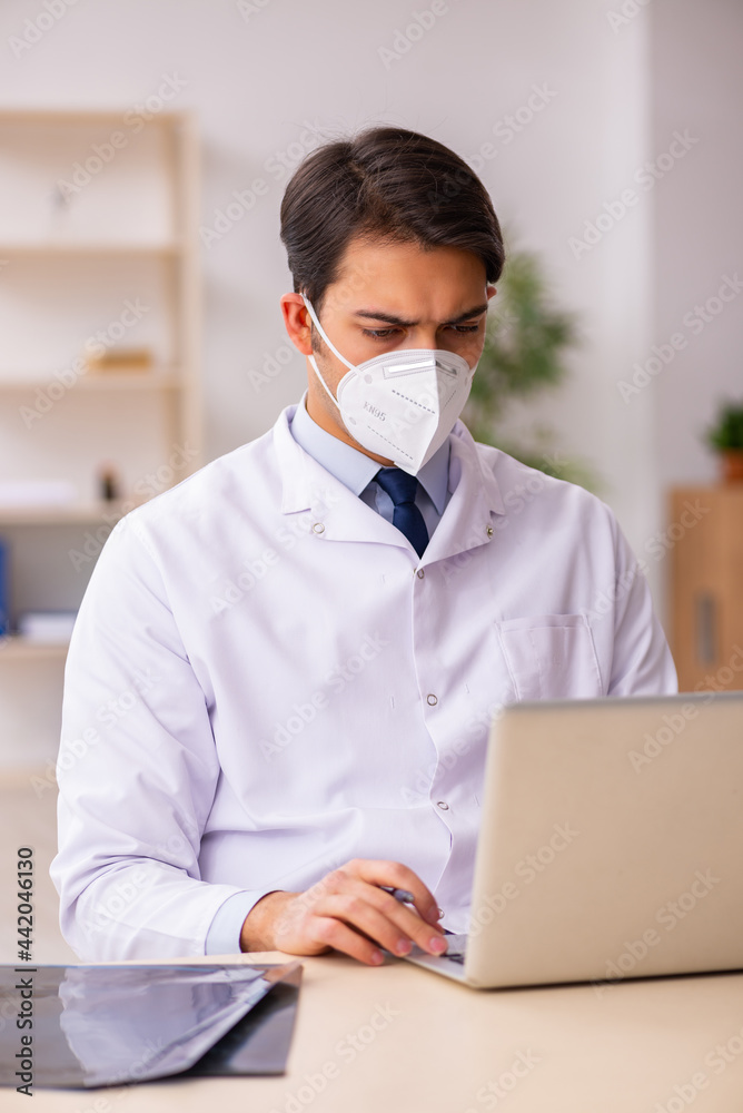 Young male doctor in telemedicine concept during pandemic Young male doctor in telemedicine concept during pandemic