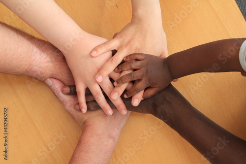 Hands young and adult layering and depicting racial harmony..