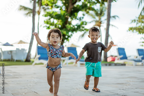 healthy cute asian fun toddler enjoy playing outside together running with friend © Odua Images