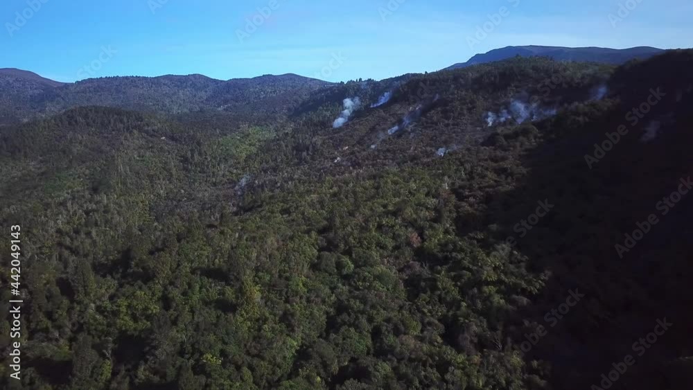 Aerial shot, of the streaming forest in Tokaanu, on a Sunny day in New Zealand, steam everywhere from the ground, wide angle Aerial shot, of the streaming forest in Tokaanu, on a Sunny day in New Zealand, steam everywhere from the ground, wide angle