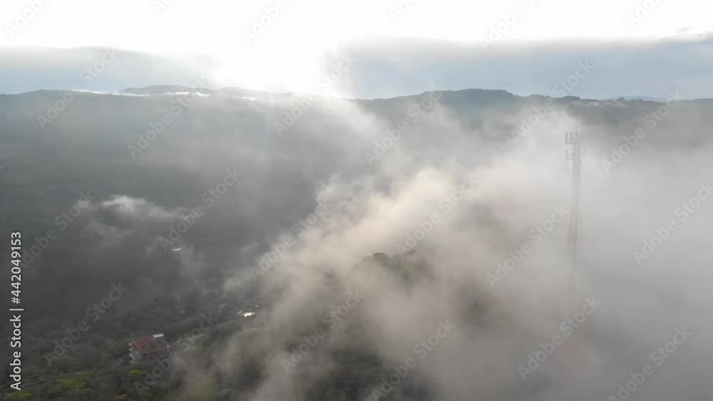 Pull front across mist, with a communication antenna in cloudy morning Pull front across mist, with a communication antenna in cloudy morning
