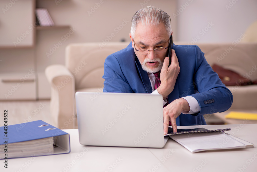 Old male employee working from home during pandemic Old male employee working from home during pandemic