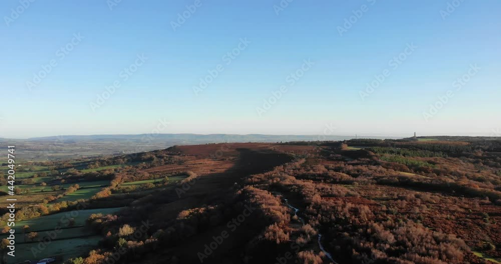 4K Aerial shot panning above the rolling hills of Culmstock Beacon in the Blackdown Hills of Devon England