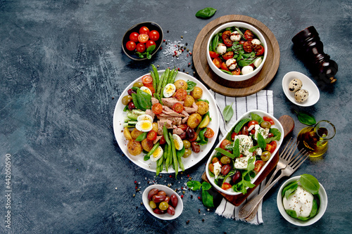 Assorted salads on dark gray background. Seasonal food concept.