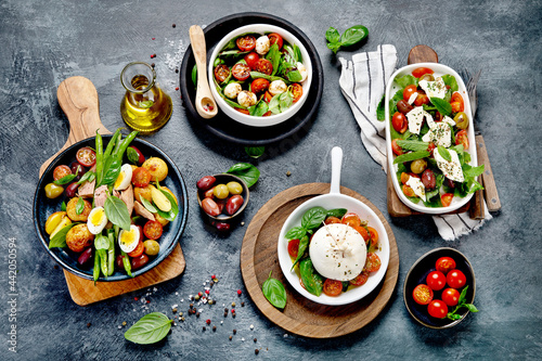 Assorted salads on dark gray background. Seasonal food concept.