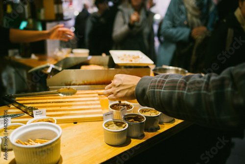 Canvas Print People tasting sauces at St
