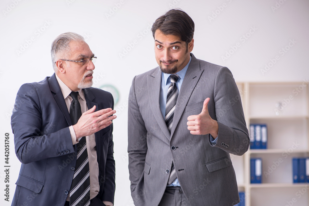 Two male employees working in the office Two male employees working in the office
