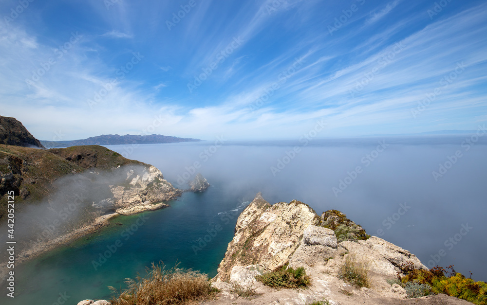 Potato Harbor overlook on Santa Cruz Island with mist coming in under blue cirrus sky in the Channel Islands National Park offshore from Santa Barbara California USA