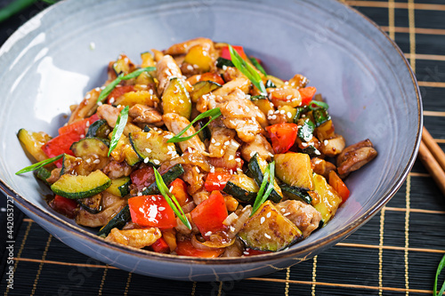 Stir fry with chicken, zucchini and sweet peppers - Chinese food.