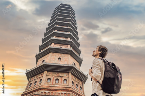 Man tourist in Temple tower of Bai Dinh pagoda in Ninh Binh, Vietnam. Resumption of tourism in Vietnam after quarantine Coronovirus COVID 19