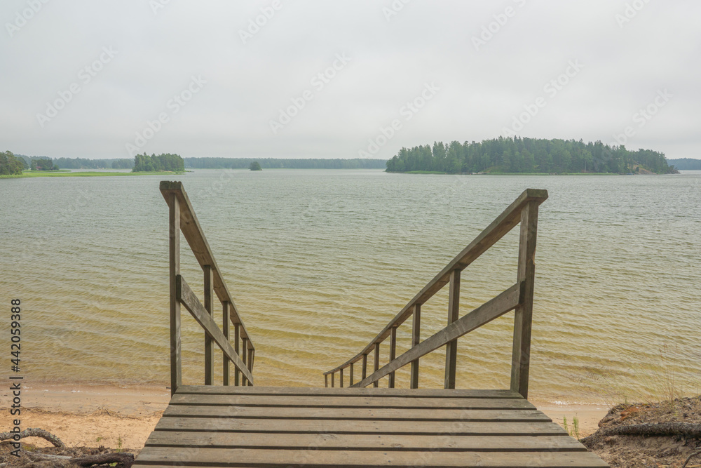 Wooden stairs to the seashore. Sandy beach, pine forest. Scandinavian nature. Finland. Porvoo Wooden stairs to the seashore. Sandy beach, pine forest. Scandinavian nature. Finland. Porvoo