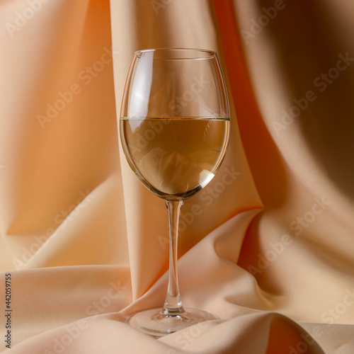 Wine collection - White wine in glass over golden background.