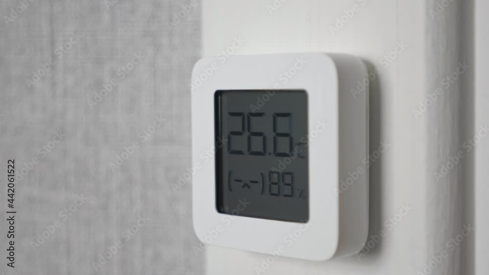 Indoor electronic thermometer shows temperature and humidity. Indoor electronic thermometer shows temperature and humidity.