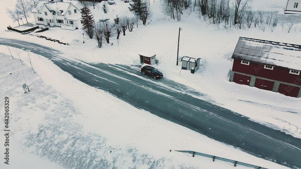 Bus Station And BMW Car Between House Structures On A Winter Landscape In Norway. aerial Bus Station And BMW Car Between House Structures On A Winter Landscape In Norway. aerial