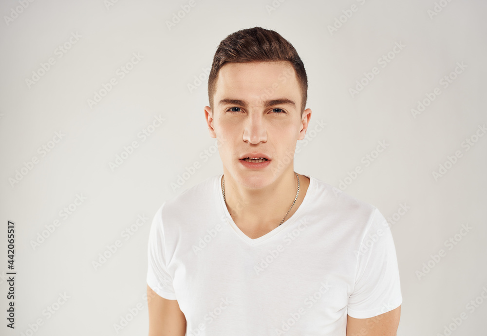 Obraz premium man with surprised facial expression in white t-shirt emotions cropped view