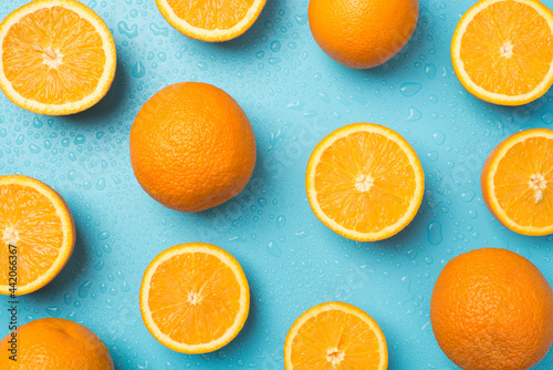 Photography Top view photo of water drops scattered cut and whole oranges on isolated light