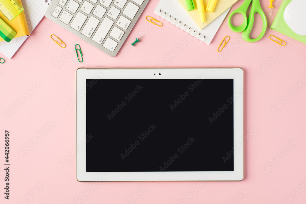 Top view photo of green and yellow stationery organizers pens clips pushpins scissors ruler stickers eraser keyboard mouse and tablet computer on isolated pastel pink background with blank space Top view photo of green and yellow stationery organizers pens clips pushpins scissors ruler stickers eraser keyboard mouse and tablet computer on isolated pastel pink background with blank space