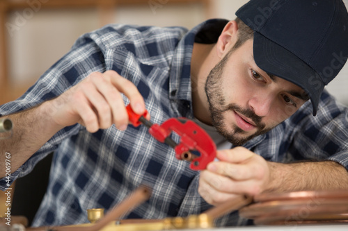 a cooper worler during pipes cutting photo