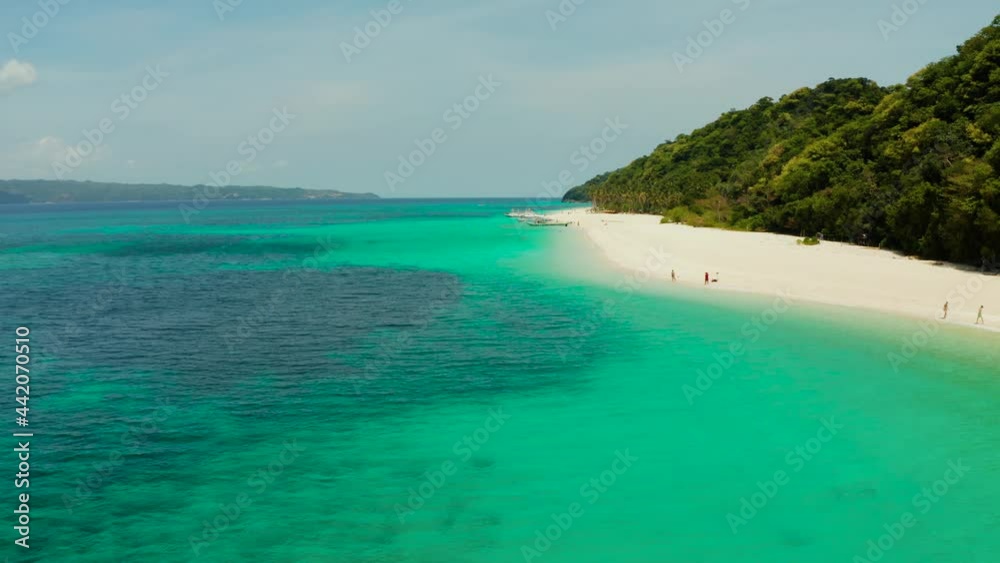 Sandy tropical beach with tourists and blue clear sea. Summer and travel vacation concept. Boracay, Philippines. Seascape with beach on tropical island. Puka shell beach Sandy tropical beach with tourists and blue clear sea. Summer and travel vacation concept. Boracay, Philippines. Seascape with beach on tropical island. Puka shell beach
